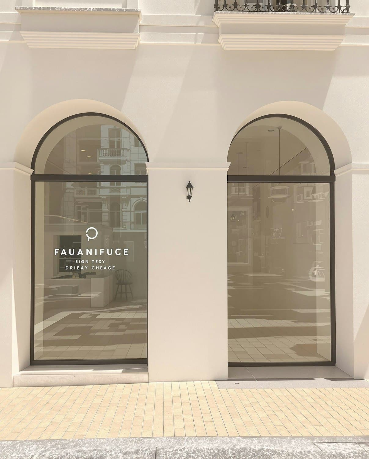 A storefront with arched windows and a cream facade